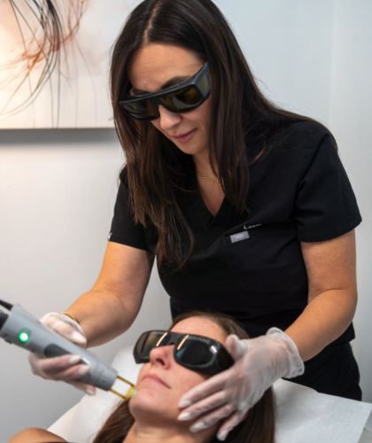 image of Laser 360 performing laser hair removal on a lady's face in Tampa, FL clinic.